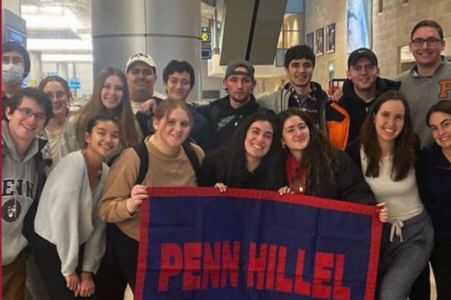 Students holding Penn Hillel banner