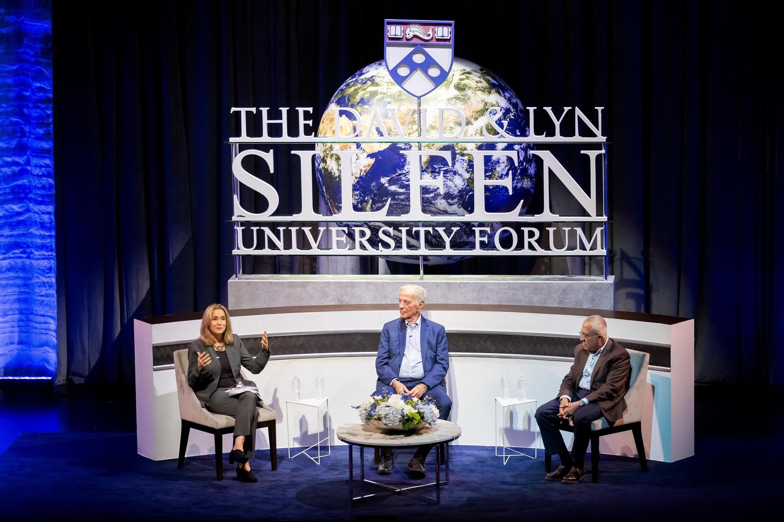 Silfen Forum moderator and panelists on stage and engaged in a lively discussion.